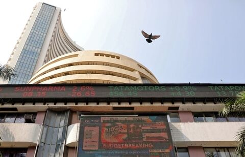 A bird flies past a screen displaying the Sensex results on the facade of the Bombay Stock Exchange (BSE) building in Mumbai.(REUTERS)