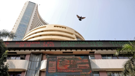 A bird flies past a screen displaying the Sensex results on the facade of the Bombay Stock Exchange (BSE) building in Mumbai.(REUTERS)