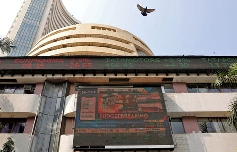A bird flies past a screen displaying the Sensex results on the facade of the Bombay Stock Exchange (BSE) building in Mumbai.(REUTERS)