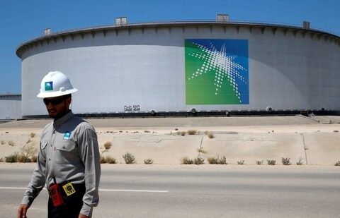 An Aramco employee walks near an oil tank at Saudi Aramco's Ras Tanura oil refinery and oil terminal in Saudi Arabia.(REUTERS)