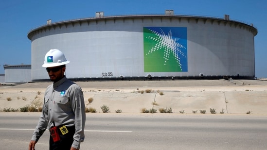 An Aramco employee walks near an oil tank at Saudi Aramco's Ras Tanura oil refinery and oil terminal in Saudi Arabia.(REUTERS)