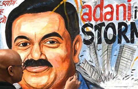 Art teacher Sagar Kambli gives final touches to a painting of Gautam Adani highlighting the ongoing crisis of the Adani group.