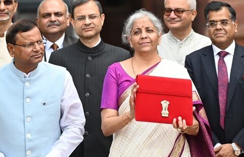 Union Finance Minister Nirmala Sitharaman showcases a red pouch carrying the Budget documents, outside the Finance Ministry in North Block (Hindustan Times)