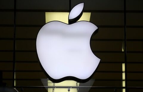 The Apple logo is illuminated at a store.(AP)