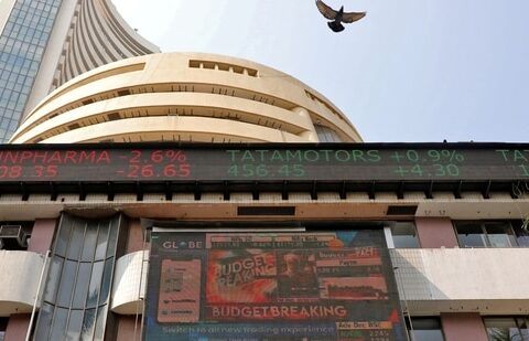 A bird flies past a screen displaying the Sensex results on the facade of the Bombay Stock Exchange (BSE) building in Mumbai.(Reuters)