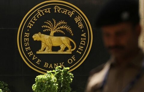 A police officer walks past the Reserve Bank of India (RBI) logo inside its headquarters in Mumbai, India.(Reuters)