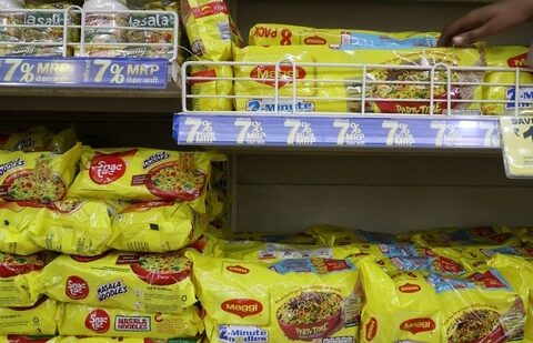 A worker arranges packets of Nestle's Maggi noodles on a shelf inside a supermarket in Mumbai, India.(Reuters)