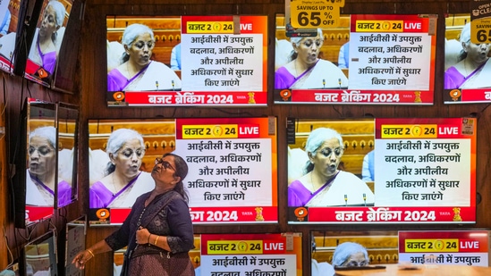 A woman watches the Union Budget 2024-25 being presented by Union finance minister Nirmala Sitharaman at a showroom in Mumbai. (PTI)