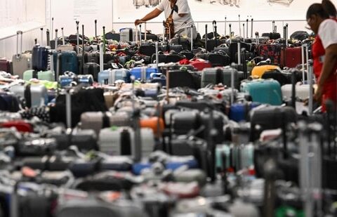 A customer looks through rows of bags awaiting reunification with their owners in the Delta Air Lines baggage claim area Los Angeles International Airport (LAX).(AFP)