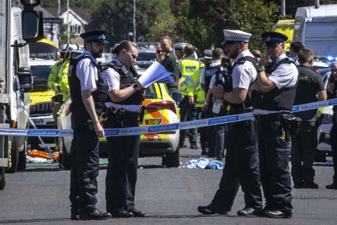 Police clash with a violent crowd gathered near the site of UK stabbing attack that killed 3 girls