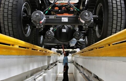 An employee inspects the engine of a BharatBenz truck inside Daimler's factory in Oragadam in Tamil Nadu.(Reuters)