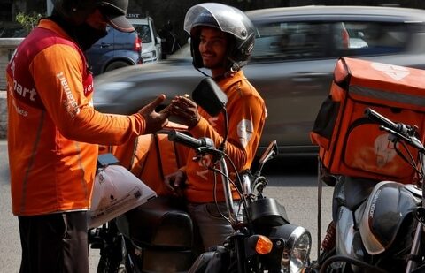 Gig workers prepare to deliver orders outside Swiggy's grocery warehouse at a market area in New Delhi, India, May 6, 2024. (Priyanshu Singh/Reuters)