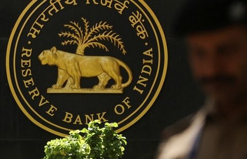 A police officer walks past the Reserve Bank of India (RBI) logo inside its headquarters in Mumbai, India.(Reuters)