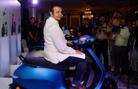 Ola Electric IPO: Bhavish Aggarwal, CEO of Ola Cabs, and founder of Ola Electric, sits on an Ola electric scooter after the press conference ahead of the company's IPO launch in Mumbai.(Reuters)