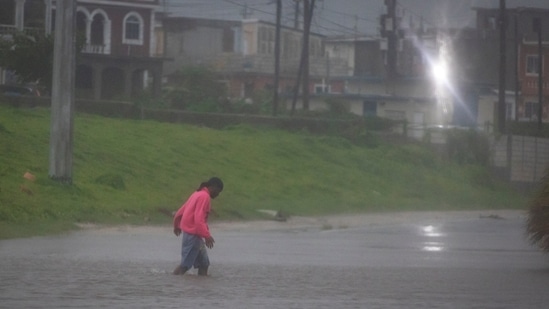 A man walks in a flooded street as Hurricane Beryl hits the southern coast of the island, in Kingston, Jamaica, July 3, 2024. (Marco Bello/Reuters)