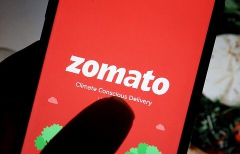 The logo of Indian food delivery company Zomato is seen on its app on a mobile phone displayed in front of its company website in this illustration picture taken July 14, 2021. (Florence Lo/Reuters)