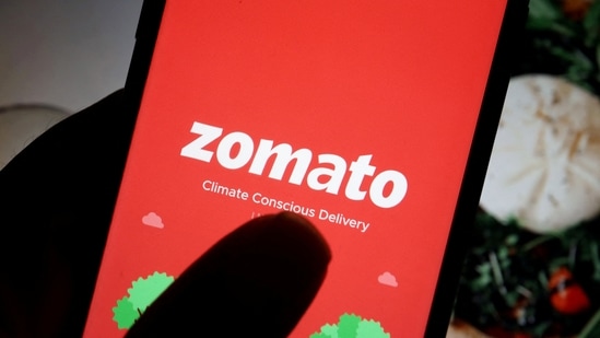 The logo of Indian food delivery company Zomato is seen on its app on a mobile phone displayed in front of its company website in this illustration picture taken July 14, 2021. (Florence Lo/Reuters)