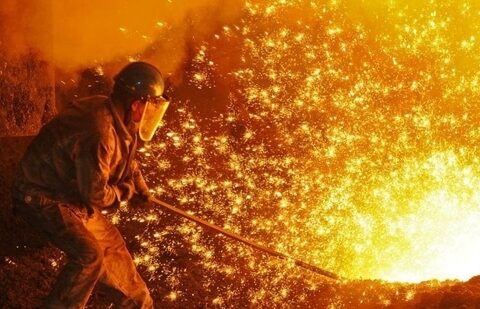 An employee works next to molten iron at a steel mill of Dongbei Special Steel in Dalian, Liaoning province, China. (Stringer/REUTERS)