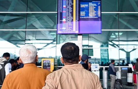 Passengers look at a flight information display as many IndiGo flights stand cancelled at Indira Gandhi International Airport in New Delhi on Friday, 5 December 2025. (ANI)