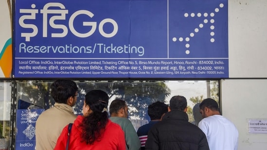 Passengers inquire at an IndiGo airlines counter amid flight disruptions at Birsa Munda Airport in Ranchi on Sunday (7 December 2025). The sight of one carrier bringing national air traffic to a near-halt underscores the danger of India’s reliance on too-big-to-falter industrial giants. (PTI)