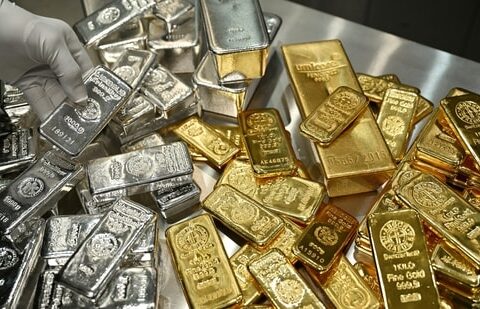 Gold and silver bars are stacked in the safe deposit boxes room of the Pro Aurum gold house in Munich, Germany. (Reuters)