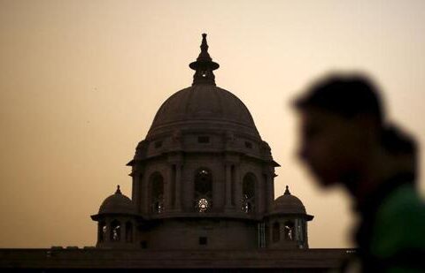 A commuter walks past the building of India's Ministry of Finance during dusk in New Delhi (REUTERS FILE)