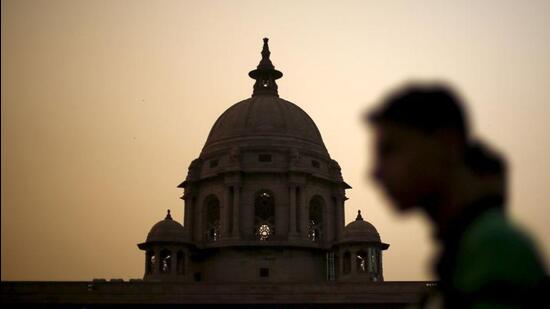 A commuter walks past the building of India's Ministry of Finance during dusk in New Delhi (REUTERS FILE)