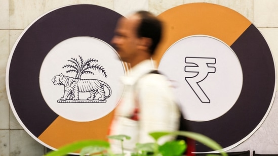A man walks past a logo of the Reserve Bank of India and the Indian Rupee inside the RBI headquarters in Mumbai. By selling US Treasury holdings, RBI can then use the funding to purchase rupees to strengthen its value. (Reuters)