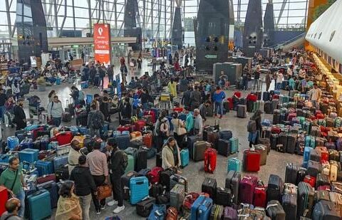 Stranded passengers search for their luggage after IndiGo cancelled several flights, at the Kempegowda International Airport, in Bengaluru on Dec. 5, 2025. (PTI)
