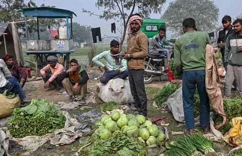 Vegetable vendors wait for customers at a local market in New Delhi (AFP FILE)