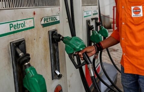 A petrol pump attendant picks up a nozzle to refuel a vehicle at an Indian Oil fuel station in Varanasi. (AFP)