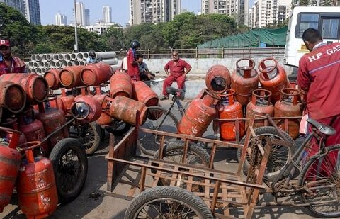 Workers load LPG cylinders in a cart in Mumbai on Wednesday, 11 March 2026. The government has raised LPG cylinder prices for the first time in nearly a year to  ₹913. (PTI)