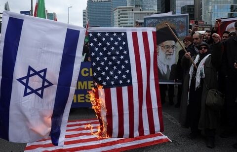 Demonstrators set fire on an Israeli and a US flag during a protest against Israel and the US strikes on Iran, following the killing of Iran’s Supreme Leader Ayatollah Ali Khamenei, outside the Israeli consulate in Istanbul, Turkey, on Sunday, 1 March 2026. (Reuters)