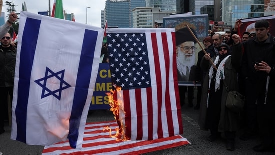 Demonstrators set fire on an Israeli and a US flag during a protest against Israel and the US strikes on Iran, following the killing of Iran’s Supreme Leader Ayatollah Ali Khamenei, outside the Israeli consulate in Istanbul, Turkey, on Sunday, 1 March 2026. (Reuters)