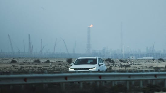 A car passes near QatarEnergy's LNG production facilities, amid the Iran war, in Ras Laffan Industrial City of Qatar on Monday, 2 March 2026. (Reuters)