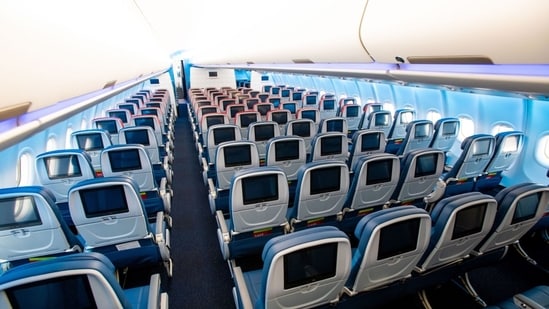 The Economy Cabin on Airplanes Keeps on Shrinking| Business News Looking down the aisle at the main cabin and Comfort Plus sections of Delta's Airbus A330neo plane.