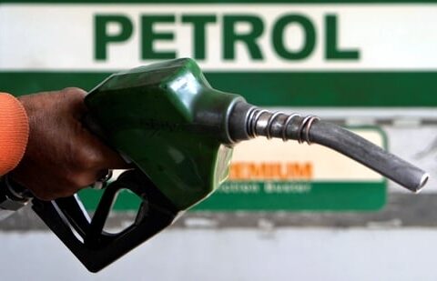 An attendant holds a petrol nozzle at a petrol pump in Siliguri. (Reuters)
