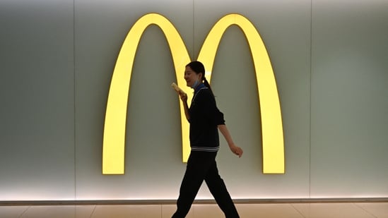 Why McDonald’s and KFC are growing like wildfire in China| Business News A woman walks past a McDonalds logo in a shopping mall in Beijing on March 4, 2026. (Photo by Pedro PARDO / AFP) (AFP)