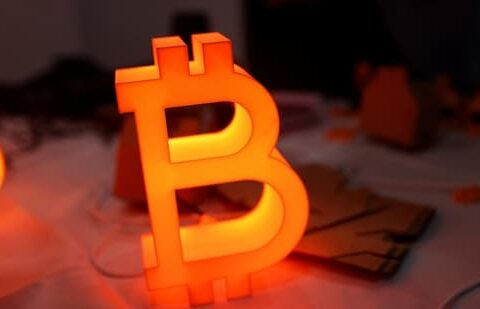 After US-Iran ceasefire, crypto’s next move hinges on oil, the dollar, and ETF flows| Business News A bitcoin light is displayed at the 'Bitcoin Treasuries Unconference' cryptocurrency event, in New York City. (Reuters File)