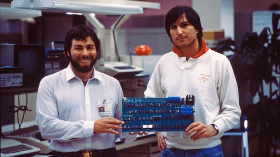 A garage startup to a cult, from turbulence to dominance| Business News Apple co-founders Steve Jobs and Steve Wozniak with an early circuit board (Official image)