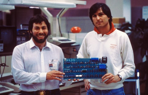 Apple co-founders Steve Jobs and Steve Wozniak with an early circuit board.