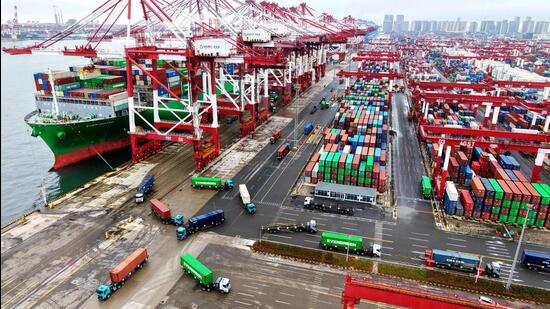 A cargo ship docked at a port with loaded containers. (AFP)