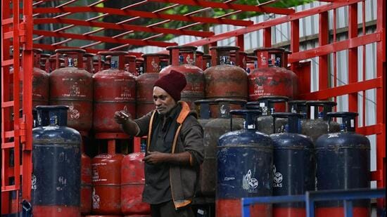 ATF, commercial LPG prices cut as Nayara rolls back March fuel price hike A delivery worker stands atop a truck carrying LPG cylinders at a distribution point in Bengaluru. (AFP)