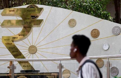FILE PHOTO: A man walks past an installation of the Rupee logo and Indian currency coins outside the Reserve Bank of India (RBI) headquarters in Mumbai, India, April 9, 2025. (REUTERS)