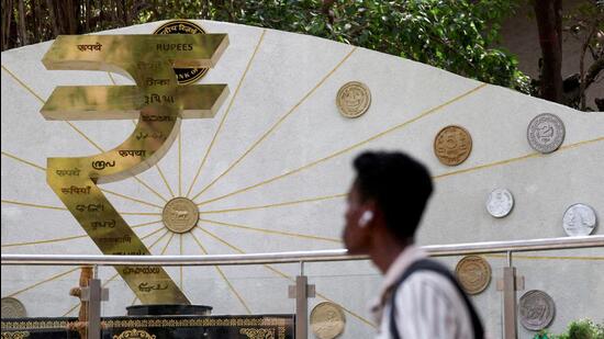 FILE PHOTO: A man walks past an installation of the Rupee logo and Indian currency coins outside the Reserve Bank of India (RBI) headquarters in Mumbai, India, April 9, 2025. (REUTERS)