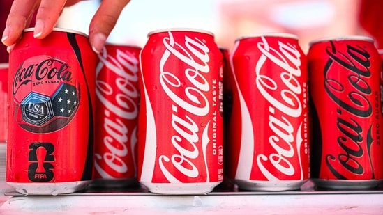 Coca-Cola beats earnings as World Cup sales boost revenue, raises 2026 forecast, while Fairlife resumes production after ransomware cyberattack. (Photo by Patrick T. Fallon / AFP) (AFP)