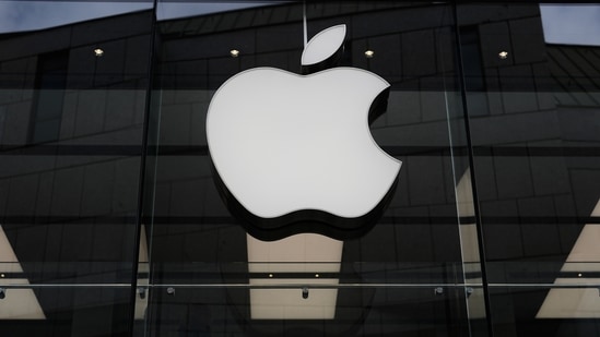 The Apple logo is illuminated at a store in Munich (AP )