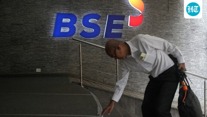 A man touches the stairs as he arrives at the Bombay Stock Exchange (BSE) building in Mumbai. (Reuters File)