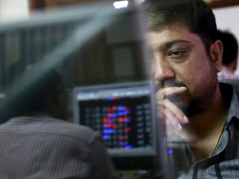 File photo: A broker reacts while trading at his computer terminal at a stock brokerage firm in Mumbai (REUTERS)