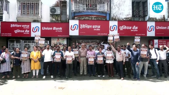 Bankers and members of the United Forum of Bank Union (UFBU) display placards during a nationwide one-day bank strike on Sept 11, demanding the implementation of a five-day workweek, in Siliguri. (ANI Video Grab)
